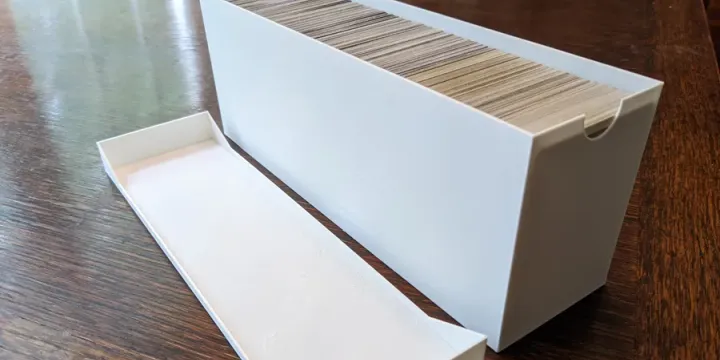 Image: 3D print of trading card container aside the container top
